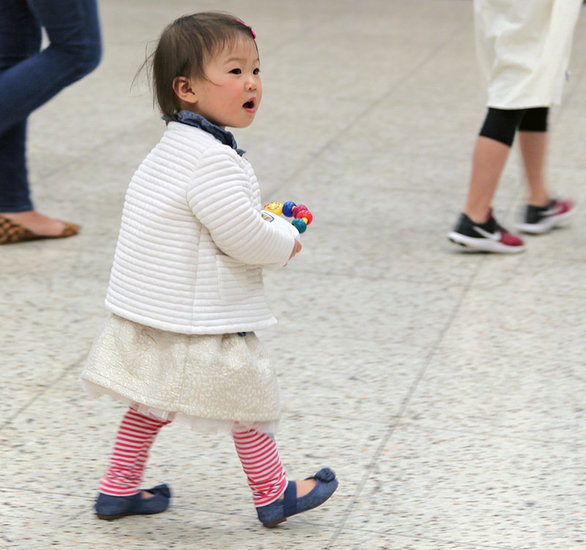 Chloe Park, 18 months, whose family is from South Korea, takes in the sights and sounds of International Night at Lynnwood Elementary School. 