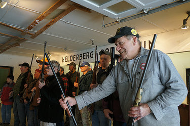Ron Bernhard passes a gun to another member of Knox’s Helderberg Rod and Gun Club 