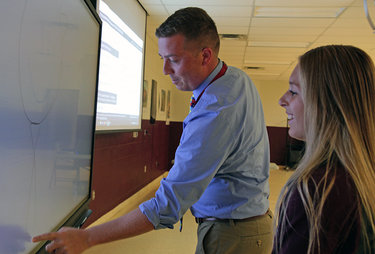 Bill Dergosits runs his fingers over a Promethean board