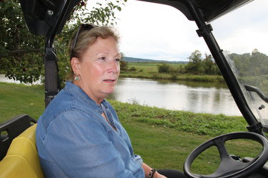 Donna Abbruzzese, seated in a golf cart