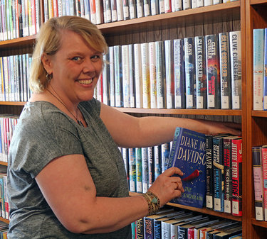 Debbie Scott, the new director of the Westerlo Public Library shelves books
