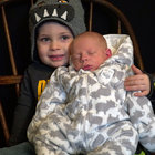 Jaxton Sims, 2, holds Tristan Sims, 2 weeks