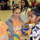 Leah Michaelides, left, and Sharanya Iyer were dressed in identical colorful Indian dresses as they prepared for their dance performance. 
